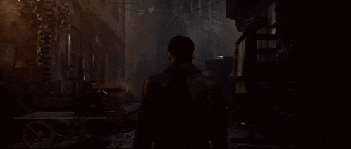 a man walking down a dark street with a sign that says ' a ' on it