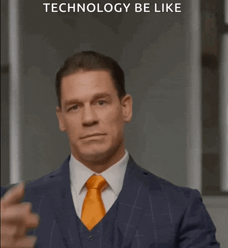 a man in a suit and tie is pointing at his forehead with the words technology be like below him
