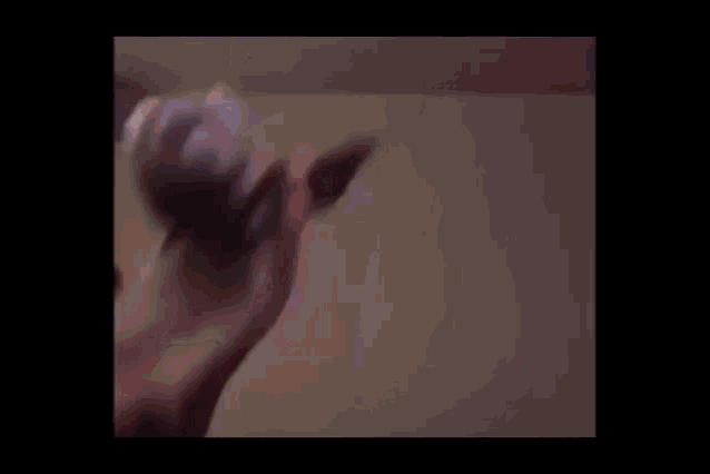 a blurry picture of a person standing on their head in a room .