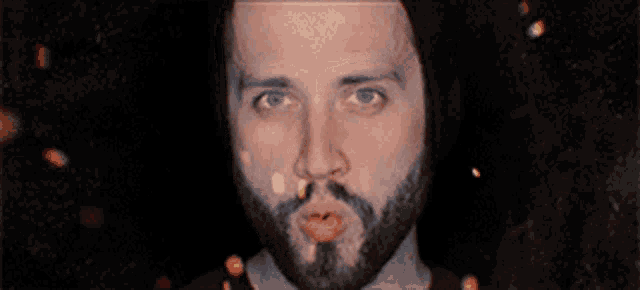 a man with a beard is making a funny face with his mouth open
