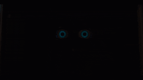 a close up of a person 's eyes that are glowing blue