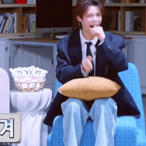 a man in a suit and tie is sitting in a chair