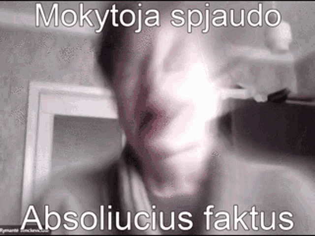 a blurry picture of a man 's face with the words mokytoja spyjaudo absoliucius faktus written on it .