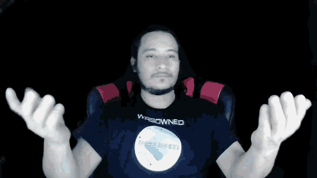 a man wearing a black shirt that says wasowned on it