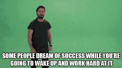 a man in a black shirt is standing in front of a green screen and making a funny face .