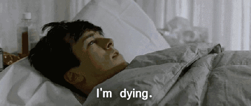 a man is laying in a bed with the words `` i 'm dying '' written above him .