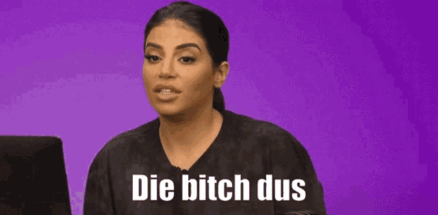 a woman is sitting in front of a laptop and says die bitch dus