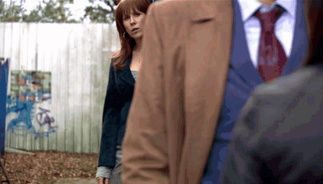 a man in a suit and tie is talking to a woman