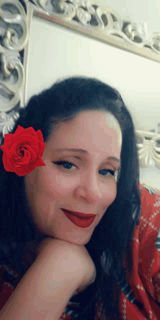 a woman with a red rose in her hair is smiling