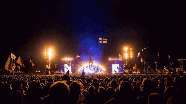 a crowd of people watching a concert with a flag that says ' n' on it