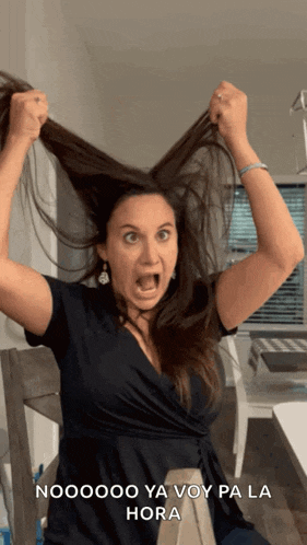 a woman is holding her hair in the air with the words nooooo ya voy pa la hora written below her