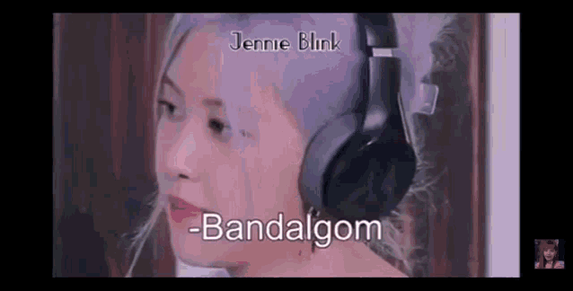 a woman with purple hair is wearing headphones and smiling .