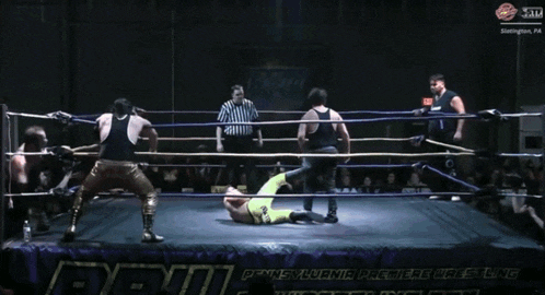 a wrestler with the number 39 on his shirt is kneeling down in a ring