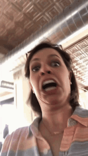 a woman making a face with her mouth open