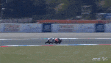 two motorcycle racers are racing on a track with the words replay at the bottom