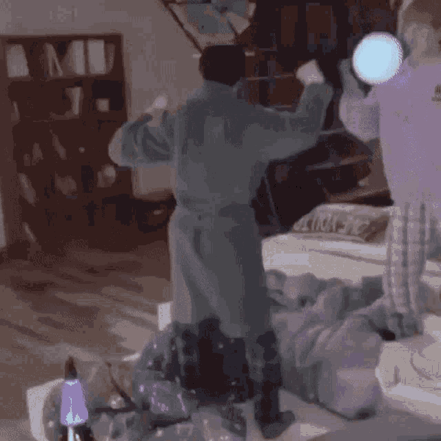 a man in a robe is standing in a room with his arms outstretched