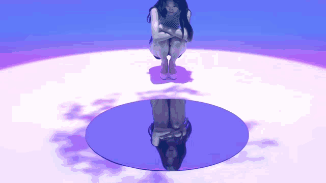 a woman kneeling down in front of a mirror with her reflection