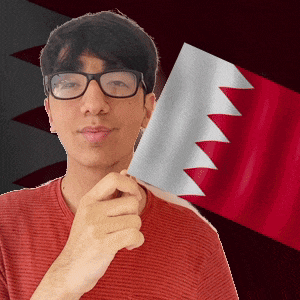 a man wearing glasses holds a flag in front of a red and white flag