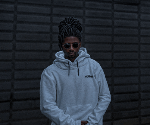 a man wearing sunglasses and a white hoodie that says rdh on it