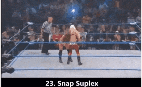 two women are wrestling in a wrestling ring with a referee watching .