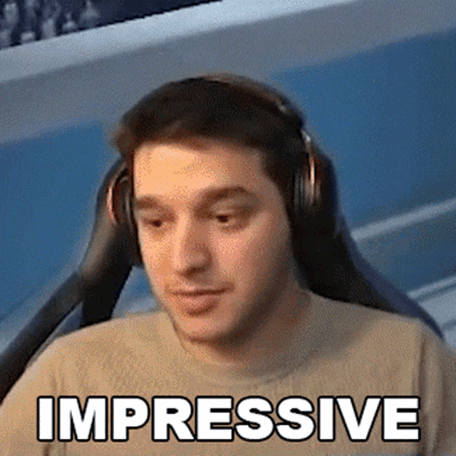 a man wearing headphones has the word impressive on his shirt