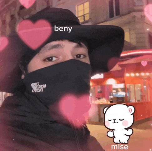 a man wearing a black face mask and a hat with the word beny on it