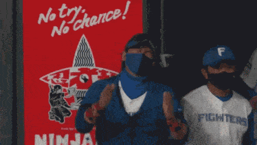 a man wearing a fighters jersey stands in front of a red ninja sign