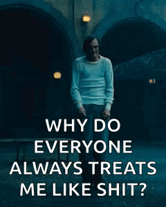 why do everyone always treats me like shit ? joker is standing in front of a building .