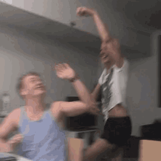 a man and a woman are dancing together in a living room .