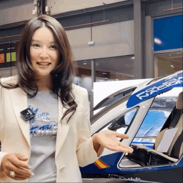 a woman is standing in front of a helicopter that says design