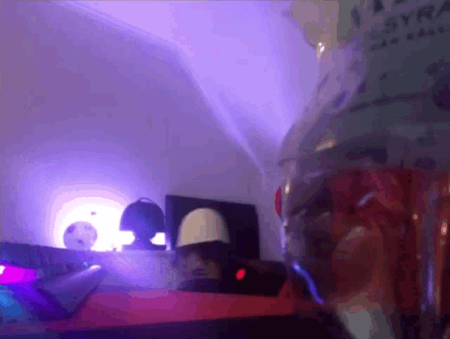 a room with a purple light and a sign that says ' i love syria '