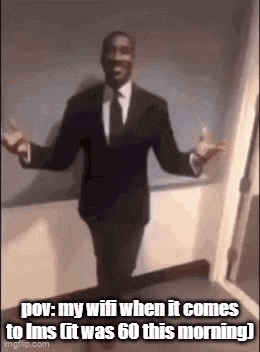 a man in a suit and tie is standing in a room with his arms outstretched and a caption .