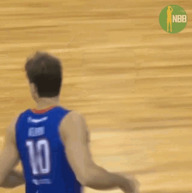 a blurry image of a basketball player with the number 10 on his jersey