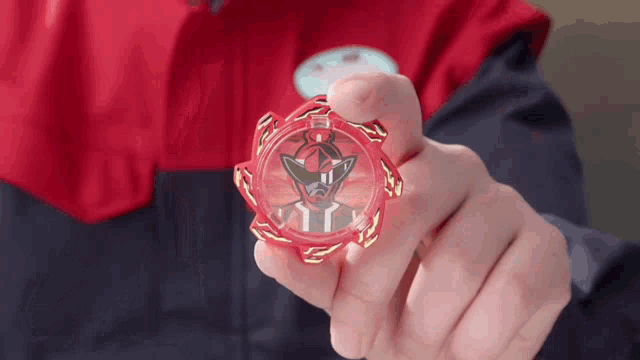 a person in a red jacket is holding a red item