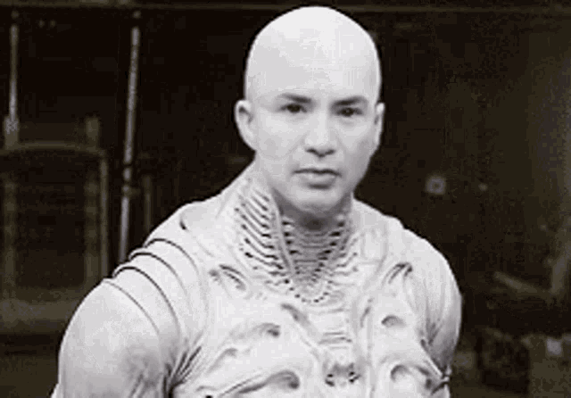 a black and white photo of a bald man wearing a skeleton costume .