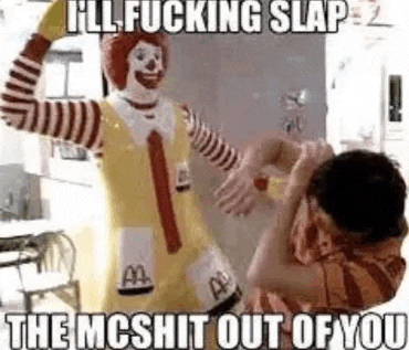 a man is standing next to a mcdonald 's mc donald statue .