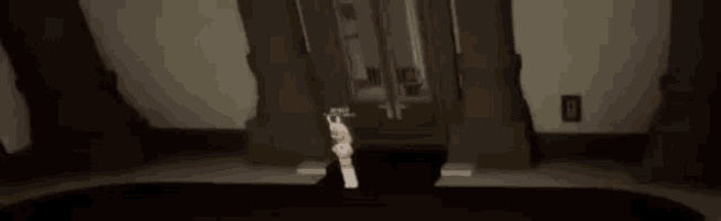 a person is standing in a dark room holding a guitar in their hand .