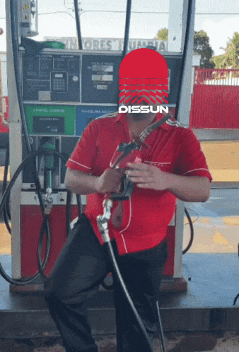 a man is sitting in front of a gas pump with a dissun logo on his face