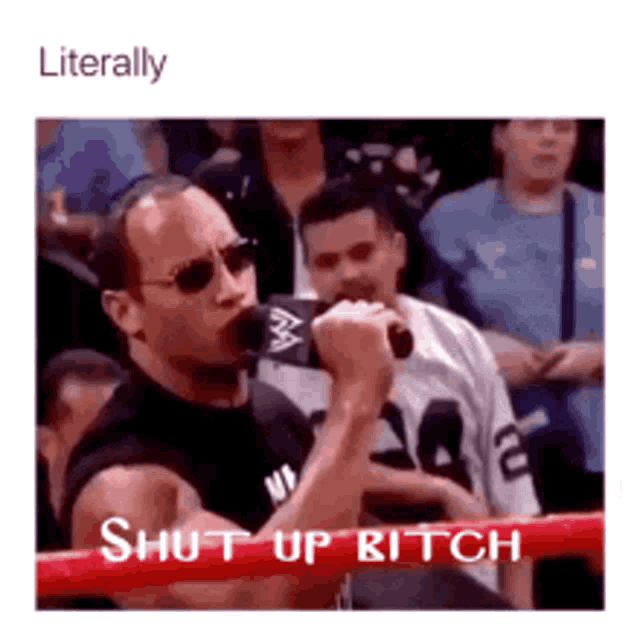 a man is standing in a boxing ring holding a microphone and says shut up bitch .