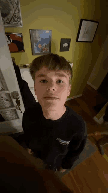 a young boy wearing a black sweatshirt with the word extreme on the front