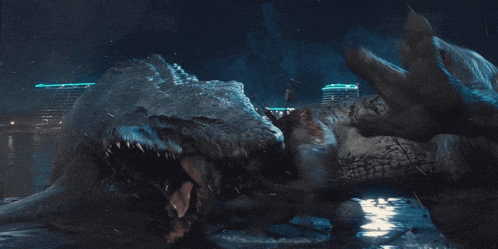 a crocodile is eating another crocodile in front of a city at night