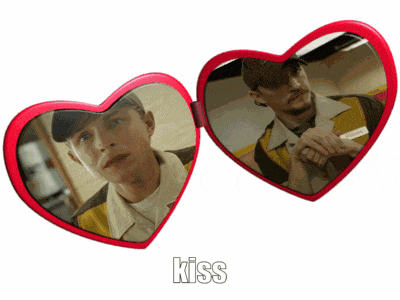 a pair of heart shaped sunglasses with the word kiss written below them