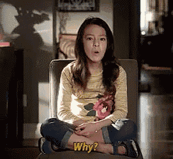 a young girl is sitting in a chair and asking why .