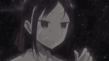 a girl with red eyes is standing in the rain looking at the camera .