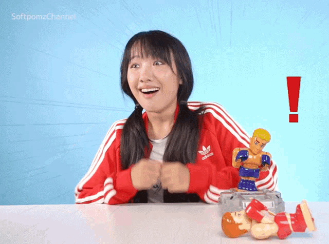 a woman wearing a red adidas jacket is smiling