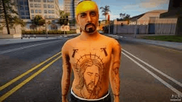 a man with a tattoo of jesus on his chest is standing in the middle of a street .