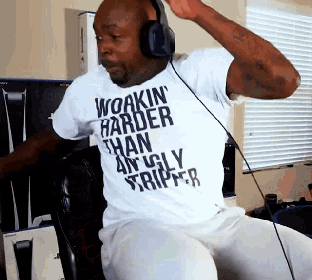 a man wearing headphones and a t-shirt that says workin harder than an ugly stripper