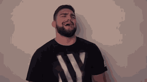 a man with a beard is wearing a black ny t-shirt