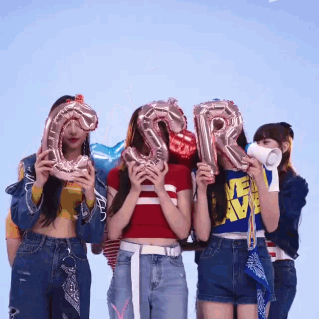 a group of girls are holding balloons that spell out the letters sr