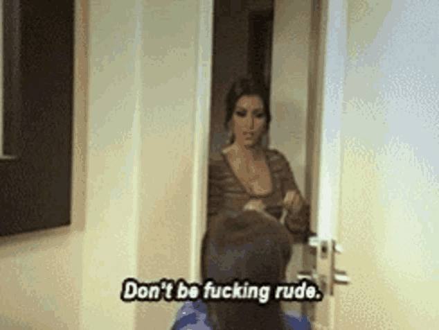 a woman is standing in a doorway talking to a man and says " don 't be fucking rude " .